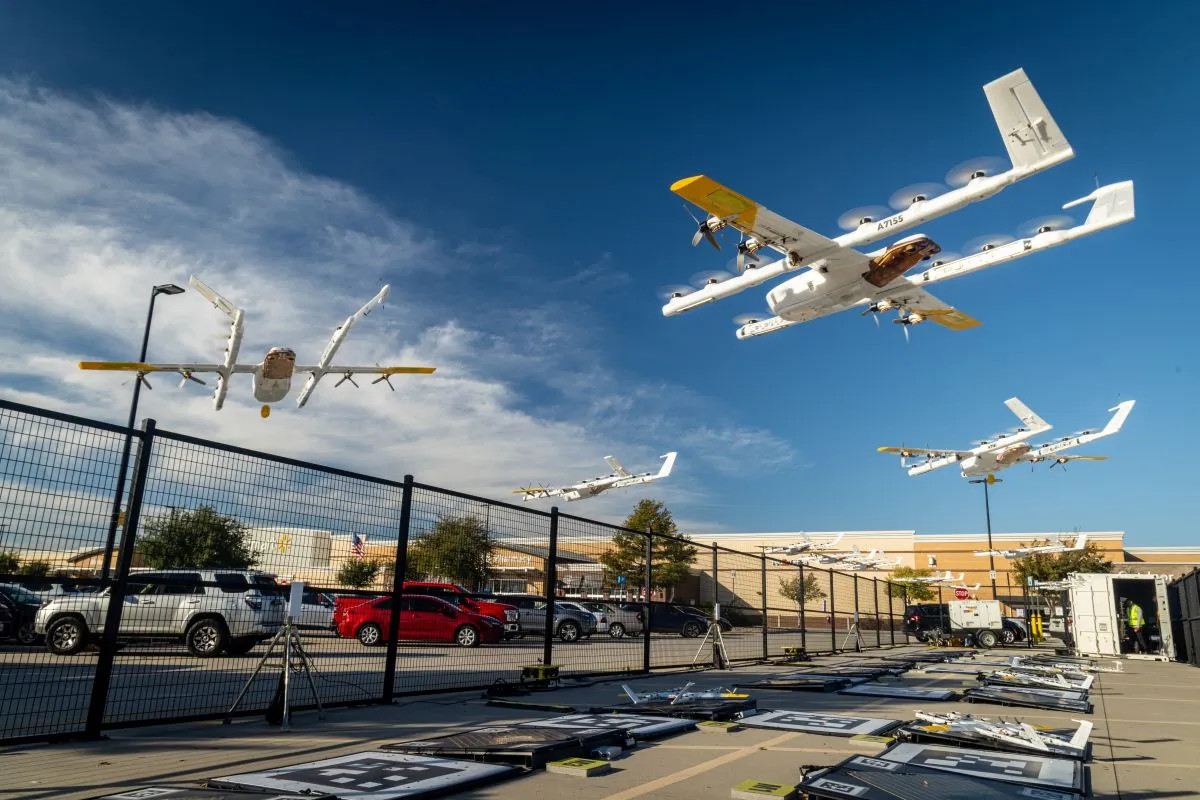 Eine Wing-Lieferdrohne schwebt über einem Wohngebiet und liefert ein Paket von Walmart aus